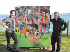 Artist Donovan Bixley (left) and Urban Design and Development Manager, John Ridd (right) with the new lakefront billboard and three rugby players.